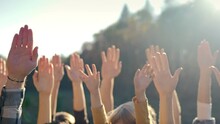 Close Up Of Rising Hands Up In The Air. Outdoor. Eco Activism Concept. People Voting For Safe Environment. Males And Females Volunteers Doing Gesture Of Vote For Global Interaction In Ecology.
