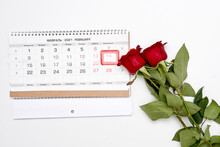 A Red Rose Next To A Calendar On A White Background With The Date Circled By A Rubber Stamp That Says Happy Valentine's Day