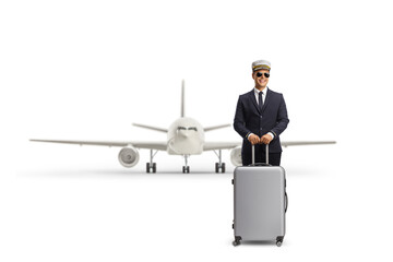 Canvas Print - Young pilot standing with a suitcase in front of an airplane