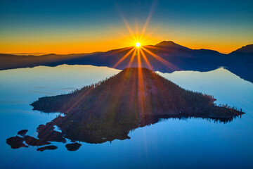 Wall Mural - view of sunrise over crater lake on a calm summer morning.