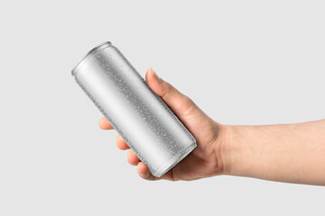 Wall Mural - Aluminium drink can 250ml with water drops in a hand mockup template, isolated on light grey background. High resolution.