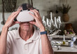 Senior man involved in medieval adventure in VR headset