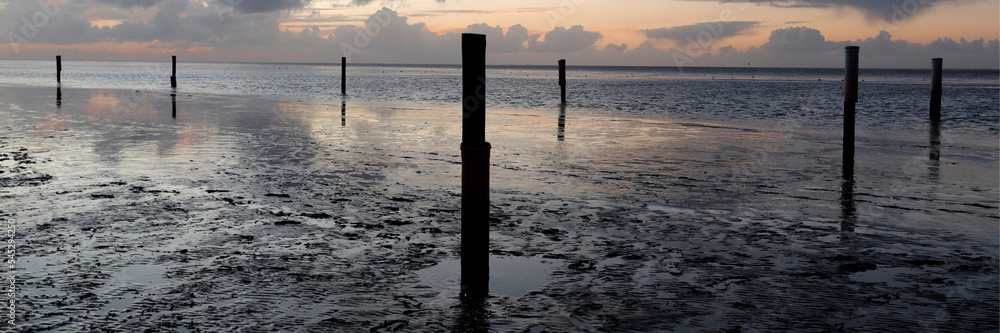 North Sea beach with tides, breakwaters, groynes and pastel sunset ...