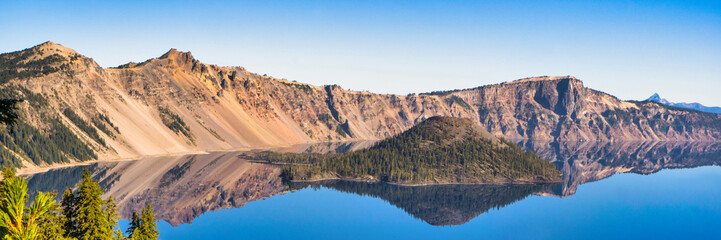 Wall Mural - panoramic view of crater lake on a calm and clear summer morning.
