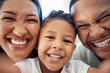 © David L/peopleimages.com - Selfie, face smile and black family in home bonding, taking photo and enjoying time together. Portrait, love and picture of girl, father and mother for happy memory, social media or online post.