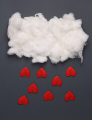 Wall Mural - Cloud with falling hearts on a gray background. Romantic, love, valentine's day concept