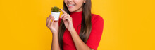 Cheerful Child With Cactus In Pot On Yellow Background