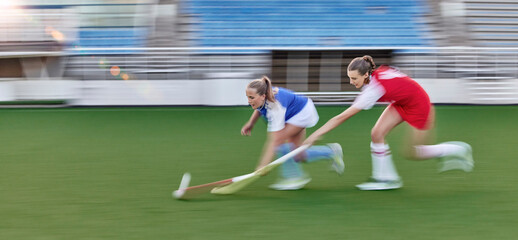 Canvas Print - Hockey, action and running women in a game, competition or sports event for goal with speed, energy and motivation challenge. Stadium, turf field and athlete people run together with stick and a ball