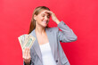 © luismolinero - Young business caucasian woman holding money isolated on red background has realized something and intending the solution