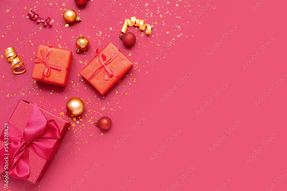 Composition with Christmas gifts, balls and confetti on red background
