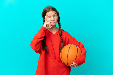 Wall Mural - Little caucasian girl playing basketball isolated on blue background thinking an idea