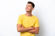 © luismolinero - Young caucasian man isolated on white background looking up while smiling