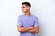 © luismolinero - Young caucasian man isolated on white background keeping the arms crossed