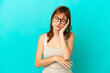 Redhead girl isolated on blue background with headache