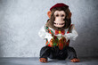 © Maria - Retro toy monkey with cymbals, jolly chimp, on gray surface