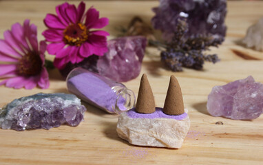 Amethyst Crystals With Flowers and Incense Cones on Meditation Table