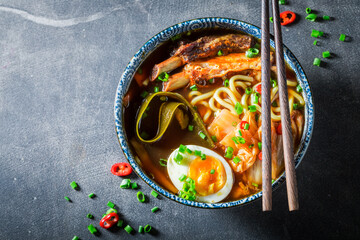 Wall Mural - Delicious and spicy Kimchi soup with noodles, eggs and chive.