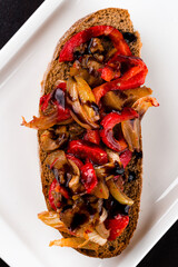 Wall Mural - Italian snack bruschetta with eggplant, tomatoes, sweet peppers, onions and sauce.