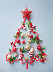 Wall Mural - christmas background made from fir tree branches, red ribbon, holly berries, decorations and lights