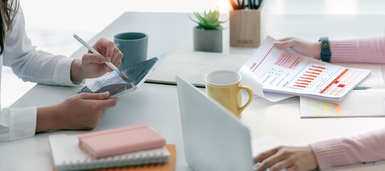 Two businesswoman advisor, business people discussing, planning analyze investment and marketing on digital tablet in office.