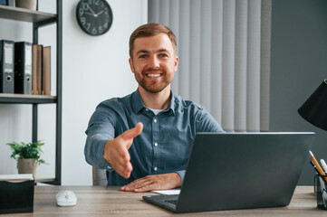 Wall Mural - Giving hand. Man is working in the modern office. Conception of business and freelance