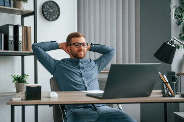 Wall Mural - Taking a break. Man is working in the modern office. Conception of business and freelance