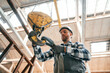 © standret - Working with crane. Man in a factory in uniform is indoors