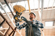 © standret - Working with crane. Man in a factory in uniform is indoors