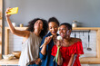 © oneinchpunch - Three mixed race hispanic and black women bonding at home - Multiracial group of happy young female adults spending time together and having fun