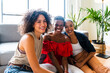 © oneinchpunch - Three mixed race hispanic and black women bonding at home - Multiracial group of happy young female adults spending time together and having fun