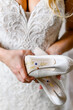 Bride holding bridal heels with writing 