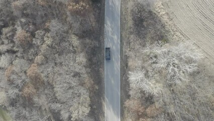 Sticker - Aerial footage of a car driving on the road in a rural area surrounded by wild nature in Missouri