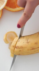 Sticker - Woman cutting a banana on the table