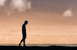 © kieferpix - Young thoughtful male silhouette walking alone outdoors thinking