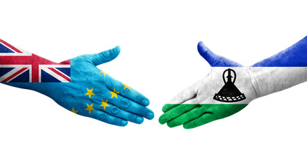 Handshake between Tuvalu and Lesotho flags painted on hands, isolated transparent image.