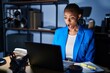 © Krakenimages.com - Beautiful african american woman working at the office at night afraid and shocked with surprise expression, fear and excited face.