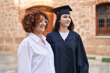 Poster - Two women mother and daughter celebrating graduation at campus university