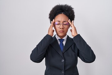 Poster - Beautiful african woman with curly hair wearing business jacket and glasses with hand on head, headache because stress. suffering migraine.