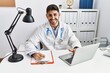 © Krakenimages.com - Handsome hispanic man working as doctor at medical consultation