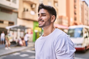 Wall Mural - Handsome hispanic man smiling happy outdoors