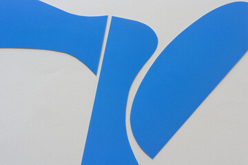 Poster - cut blue paper shapes arranged on blank paper