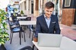 © Krakenimages.com - Young man business worker using laptop sitting on table at coffee shop terrace