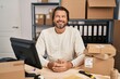 © Krakenimages.com - Handsome middle age man working at small business ecommerce with a happy and cool smile on face. lucky person.