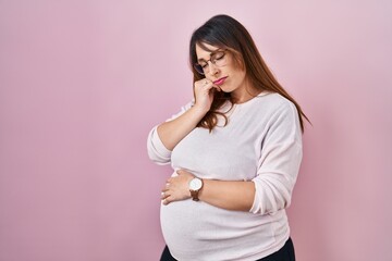 Poster - Pregnant woman standing over pink background thinking looking tired and bored with depression problems with crossed arms.