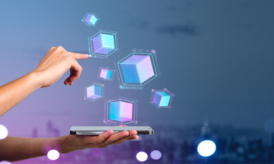 Businesswoman holding smartphone touching digital interface with virtual cubes