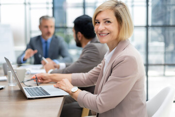 Poster - business woman with her staff, people group in background at modern bright office indoors.