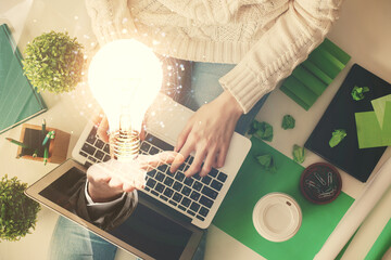 Poster - Double exposure of woman hands working on computer and light bulb hologram drawing. Top View. Idea concept.