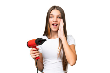 Teenager Caucasian girl holding a hairdryer over isolated background shouting with mouth wide open