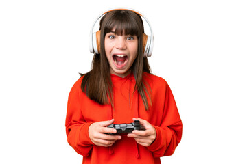 Little caucasian girl playing with a video game controller over isolated background with surprise facial expression