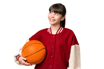 Wall Mural - Little caucasian girl playing basketball over isolated background thinking an idea while looking up